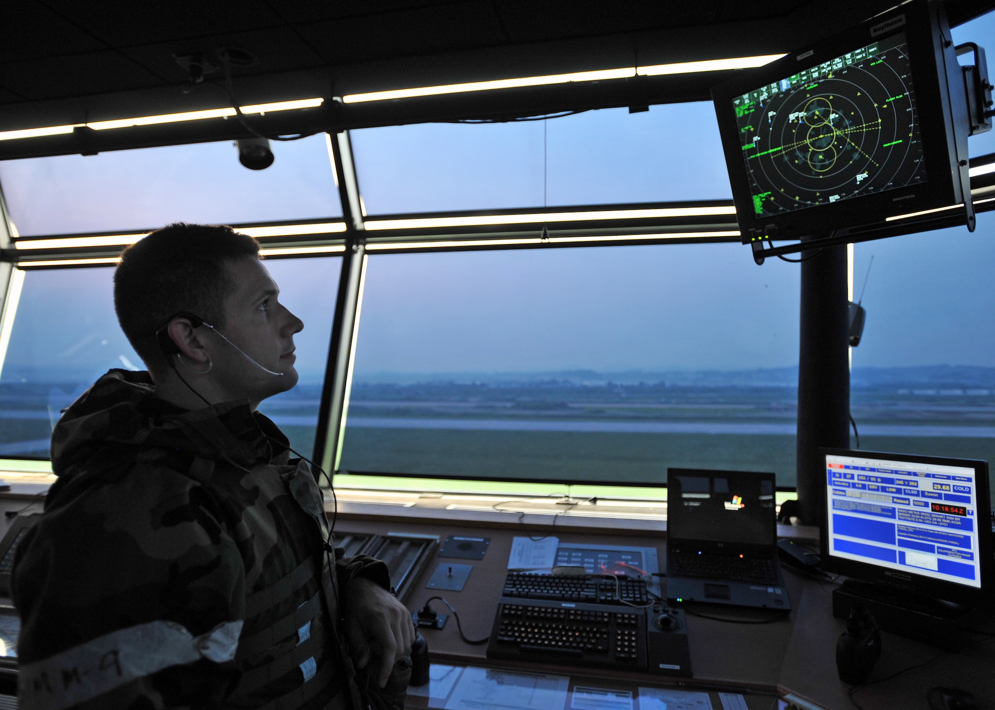 Senior Airman Joshua Griffith, 51st Operations Support Squadron air traffic controller, looks at a radar in the control tower during Operational Readiness Exercise Beverly Midnight 13-03 at Osan Air Base, Republic of Korea, August 7, 2013. During the exercise, Osan Airmen were tested on their ability to incorporate their chemical, biological, radiological and nuclear training into their daily operations. (U.S. Air Force photo/Senior Airman Siuta B. Ika)