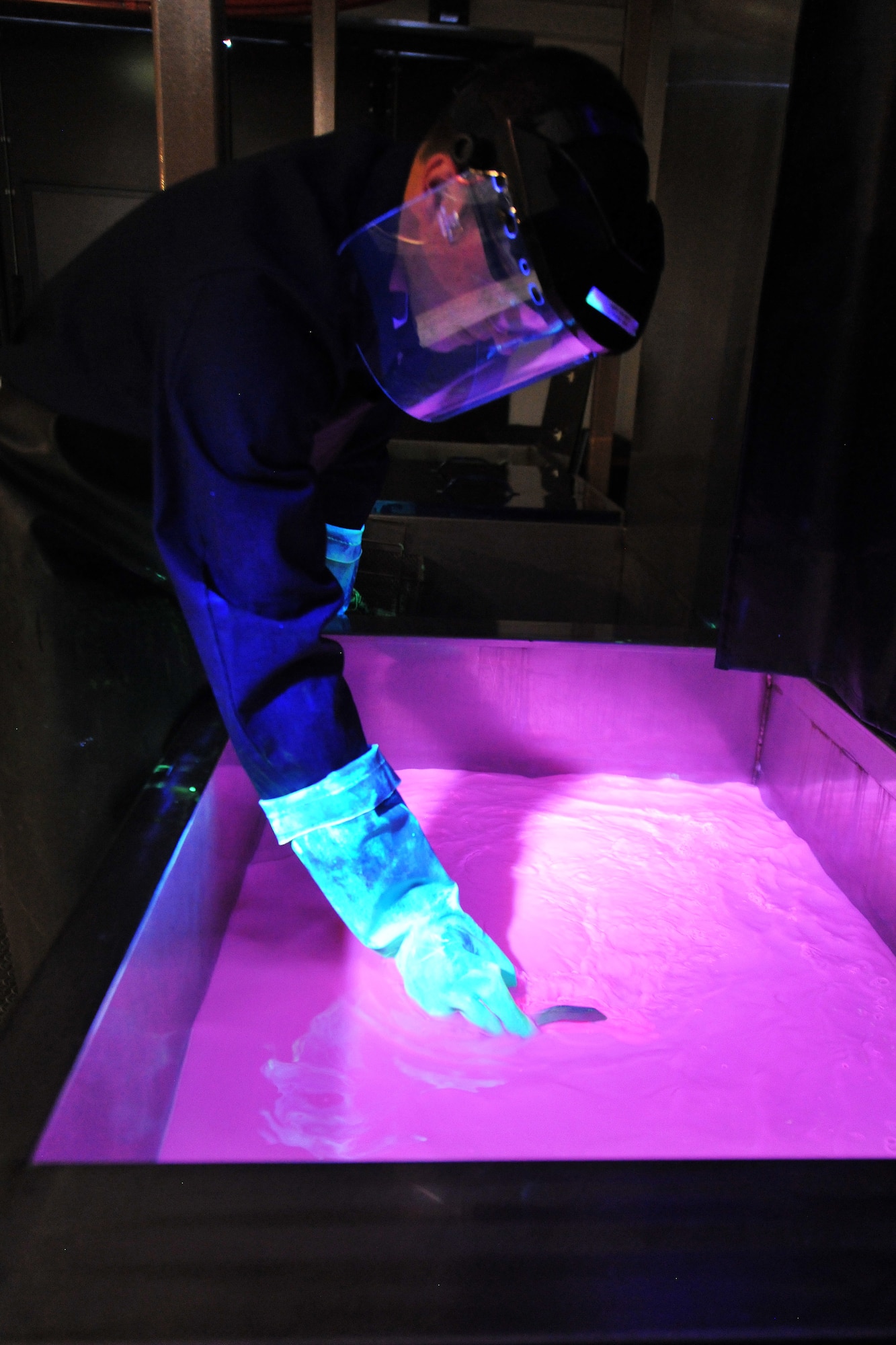 Staff Sgt. Joshua Paserba, 86th Maintenance Squadron nondestructive inspection technician, performs a step in the penetrant inspection process, July 31, 2013, Ramstein Air Base, Germany.  This part in the process uses an emulsifying bath, which removes traces of excess penetrant, allowing crack indications to be more readily visible.  (U.S. Air Force photo/Senior Airman Chris Willis)