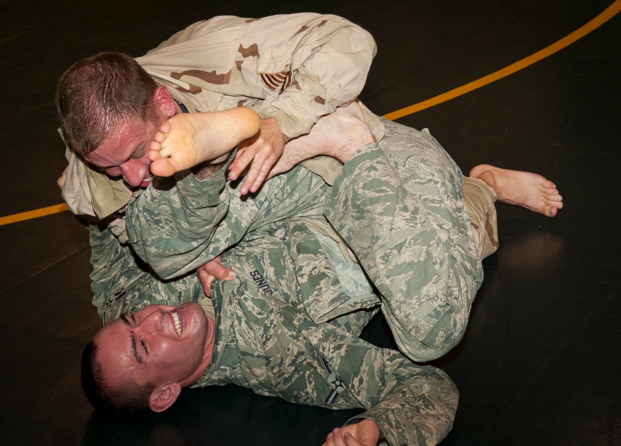 U.S. Air Force Staff Sgt. Christian Coleman, Misawa Combatives instructor, and Airman 1st Class Michael Jones, Misawa Combatives participant, grapple at the Misawa Combatives class at Misawa Air Base, Japan, July 30, 2013. Seventeen Airmen moved on to Level 2 of the Misawa Combatives Program, which is organized and led by Coleman. (U.S. Air Force photo by Airman 1st Class Zachary Kee) 