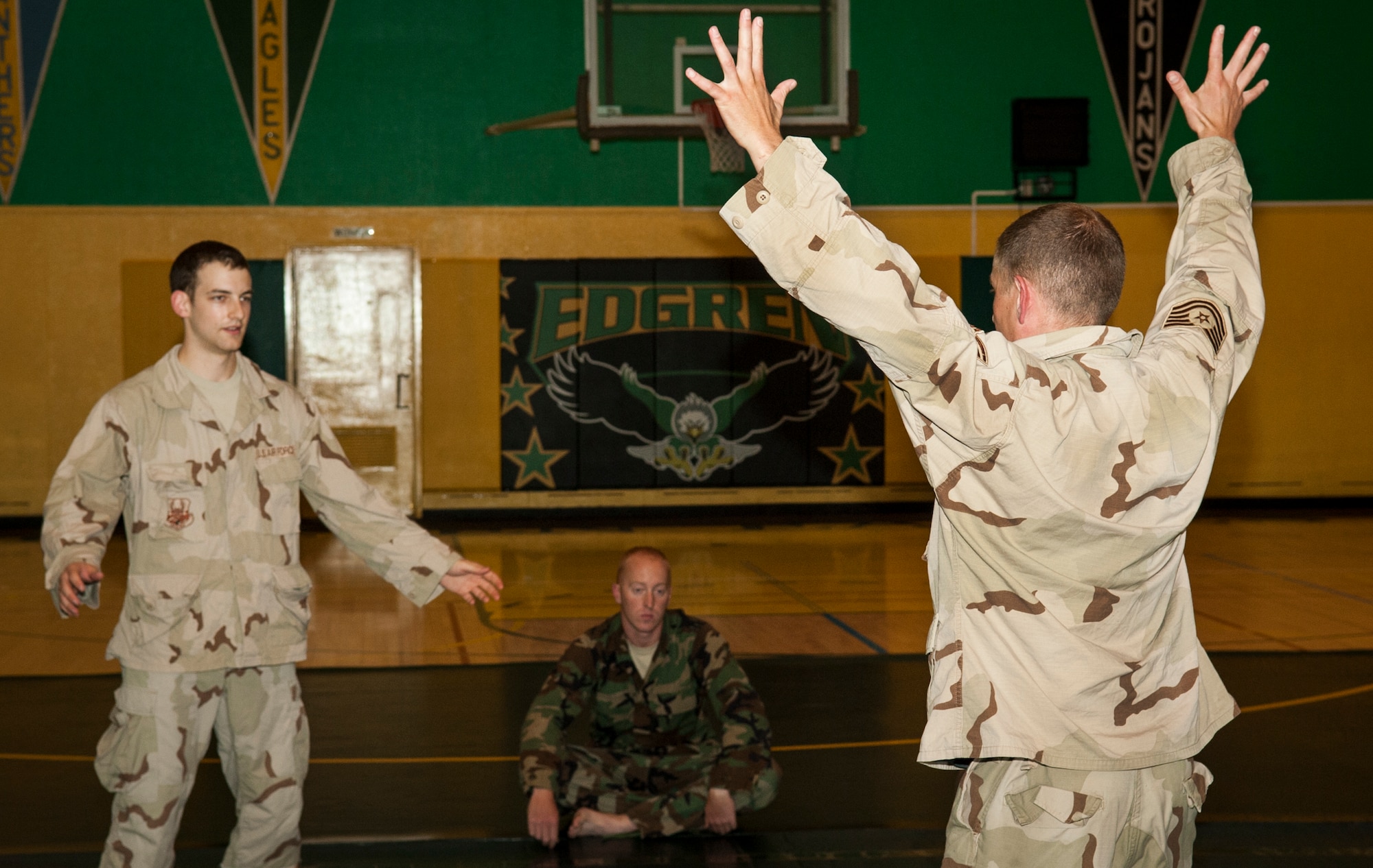 U.S. Air Force Staff Sgt. Christian Coleman, right, Misawa Combatives instructor, and Senior Airman Scott Cross, Misawa Combatives participant, demonstrate apprehension procedures during combatives training at Misawa Air Base, Japan, July 30, 2013. The Misawa Combatives Program, led by Coleman, is in Level 2 of its training and shadows the Modern Army Combatives Program. (U.S. Air Force photo by Airman 1st Class Zachary Kee)