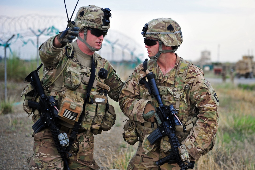 U.S. Army 1st Lt. Andrews Kearns, left, provides direction to U.S. Army Pvt. 1st Class Bryce Mickelson, right, during a mass casualty exercise on Forward Operating Base Salerno, Afghanistan, Aug. 6, 2013. Kearns, a platoon leader, and Mickelson are assigned to Company W, 2nd Battalion, 506th Infantry Regiment.