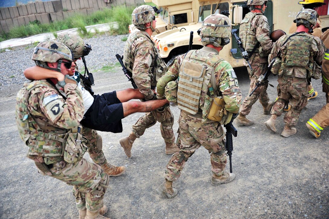 U.S. soldiers transport a simulated casualty to the casualty collection point during a mass casualty exercise on Forward Operating Base Salerno, Afghanistan, Aug. 6, 2013.