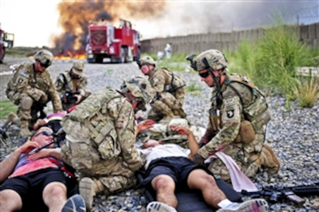 U.S. soldiers provide medical care to a simulated casualties during a mass casualty exercise on Forward Operating Base Salerno, Afghanistan, Aug. 6, 2013.The exercise is designed to test the medical systems and protocols of a unit's ability to quickly and efficiently locate, triage and treat casualties.
