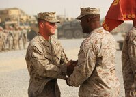 Cpl. Ryan T. McSweeney (left), a Middletown, Ohio, native and recovery vehicle operator with Transportation Support Company, Combat Logistics Regiment 2, Regional Command (Southwest), shakes hands with Col. Dwayne A. Whiteside, the commanding officer of CLR-2, after receiving the Navy and Marine Corps Achievement Medal with Combat Distinguishing Device during an award ceremony at Camp Leatherneck, Afghanistan, July 23, 2013. McSweeney earned the award for his courage and initiative during an insurgent assault on Forward Operating Base Shir Ghazi in Helmand province. 