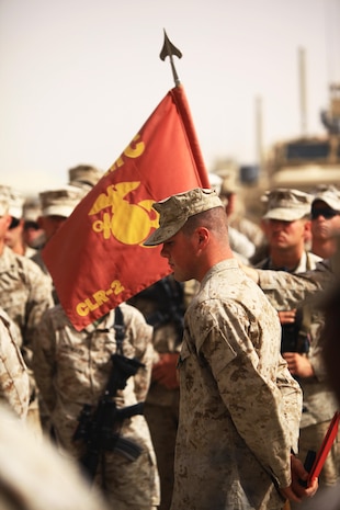 Cpl. Ryan T. McSweeney (right), a Middletown, Ohio, native and recovery vehicle operator with Transportation Support Company, Combat Logistics Regiment 2, Regional Command (Southwest), stands before his fellow servicemembers after receiving the Navy and Marine Corps Achievement Medal with Combat Distinguishing Device during an award ceremony at Camp Leatherneck, Afghanistan, July 23, 2013. McSweeney responded to the site of a suicide vehicle-borne improvised explosive device and helped repel an insurgent assault on Forward Operating Base Shir Ghazi in Helmand province, May 13, 2013.  
