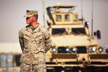 Cpl. Ryan T. McSweeney (right), a Middletown, Ohio, native and recovery vehicle operator with Transportation Support Company, Combat Logistics Regiment 2, Regional Command (Southwest), waits to receive the Navy and Marine Corps Achievement Medal with Combat Distinguishing Device during an award ceremony at Camp Leatherneck, Afghanistan, July 23, 2013. McSweeney remained visibly humble after the ceremony, stating a simple thanks to the servicemembers gathered in his honor. 