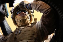 Cpl. Kenneth Benton, a technical controller with Transportation Support Company, Combat Logistics Regiment 2, Regional Command (Southwest), grimaces in his machine-gun turret during a combat logistics patrol in Helmand province, Afghanistan, July 25, 2013. Benton served as a turret gunner during the patrol, which delivered equipment and supplies to Marines serving on forward operating bases in the area around Camp Leatherneck