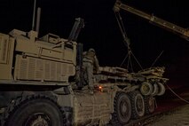 A Marine with Combat Logistics Regiment 2, Regional Command (Southwest), monitors the hoisting of a broken mine roller during a recovery operation near Camp Leatherneck, Afghanistan, July 26, 2013. CLR-2’s combat logistics patrol prepared to reenter the base when the mine roller broke, launching an extensive recovery operation to clear the road leading toward the base.