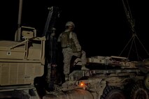 A Marine with Combat Logistics Regiment 2, Regional Command (Southwest), monitors the hoisting of a broken mine roller during a recovery operation near Camp Leatherneck, Afghanistan, July 26, 2013. A combat logistics patrol was preparing to reenter the base when the mine roller broke, launching a recovery operation to clear the road leading toward the base.