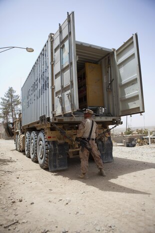 Sgt. Arthur Doers, a native of Iron Mountain, Mich., and Marine Corps Community Services specialist with Combat Logistics Regiment 2, Regional Command (Southwest), opens his truck of goods at Forward Operating Base Kajaki in Helmand province, Afghanistan, Aug. 4, 2013. Doers provided access to various hygiene, uniform and food commodities rarely seen by servicemembers operating in isolated areas. 