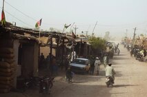 Afghans move through a market near a Forward Operating Base Kajaki, Helmond province, Afghanistan, Aug. 4, 2013. A combat logistics patrol passed through the area while helping to provide security for a mobile Post Exchange moving to various forward operating bases in the area. 