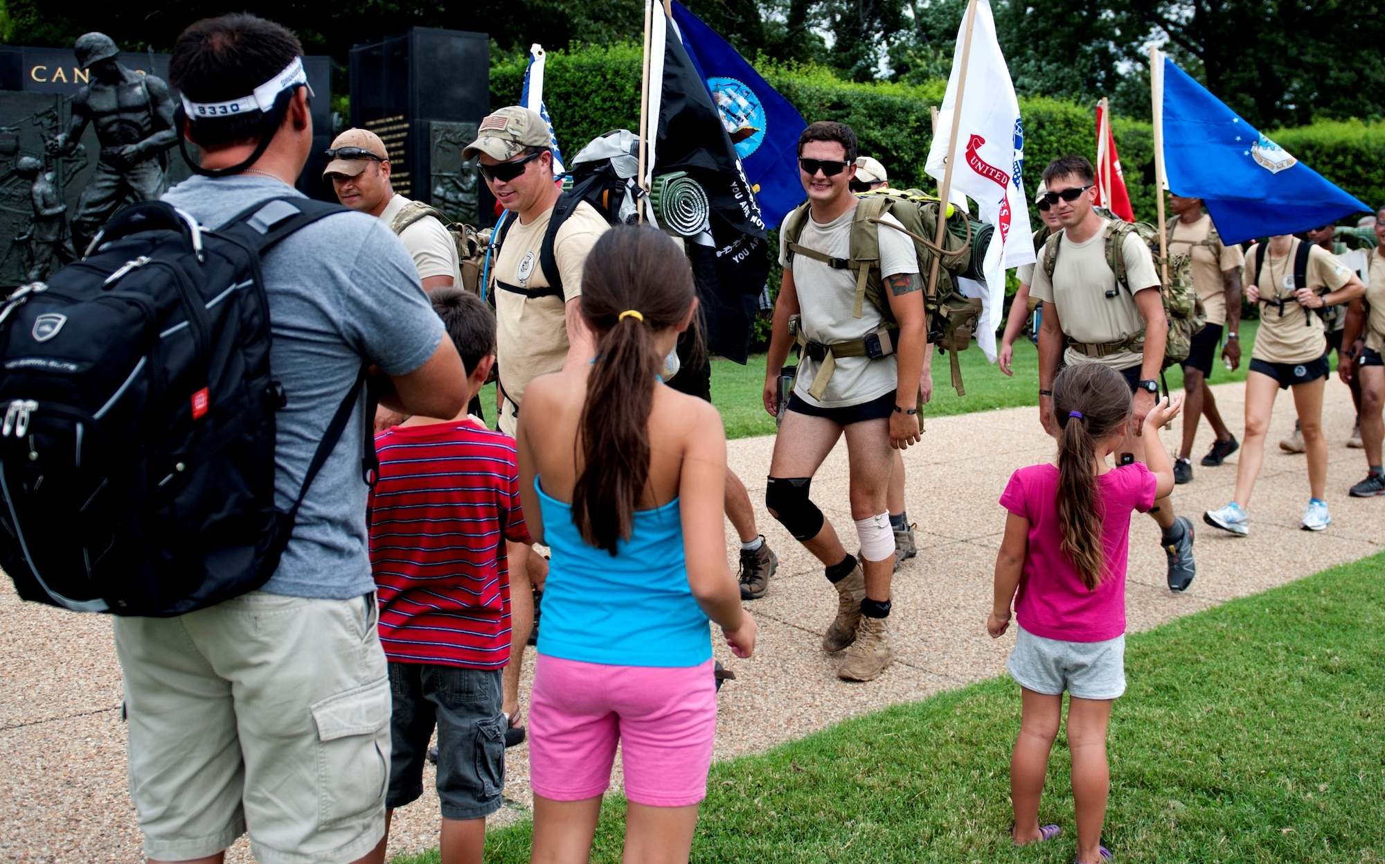 Family members cheer on “Delta Flight” as they approach the end of their 140-mile ruck march in honor of Maj. David Gray, Aug. 8, 2013. “DG” 140 is a 140-mile memorial ruck march for Gray, beginning at the Casualty Reception Center at Dover Air Force Base, Del., to Gray’s headstone at Arlington National Cemetery in Virginia, Aug 4-8. (U.S. Air Force photo/Senior Airman Carlin Leslie)