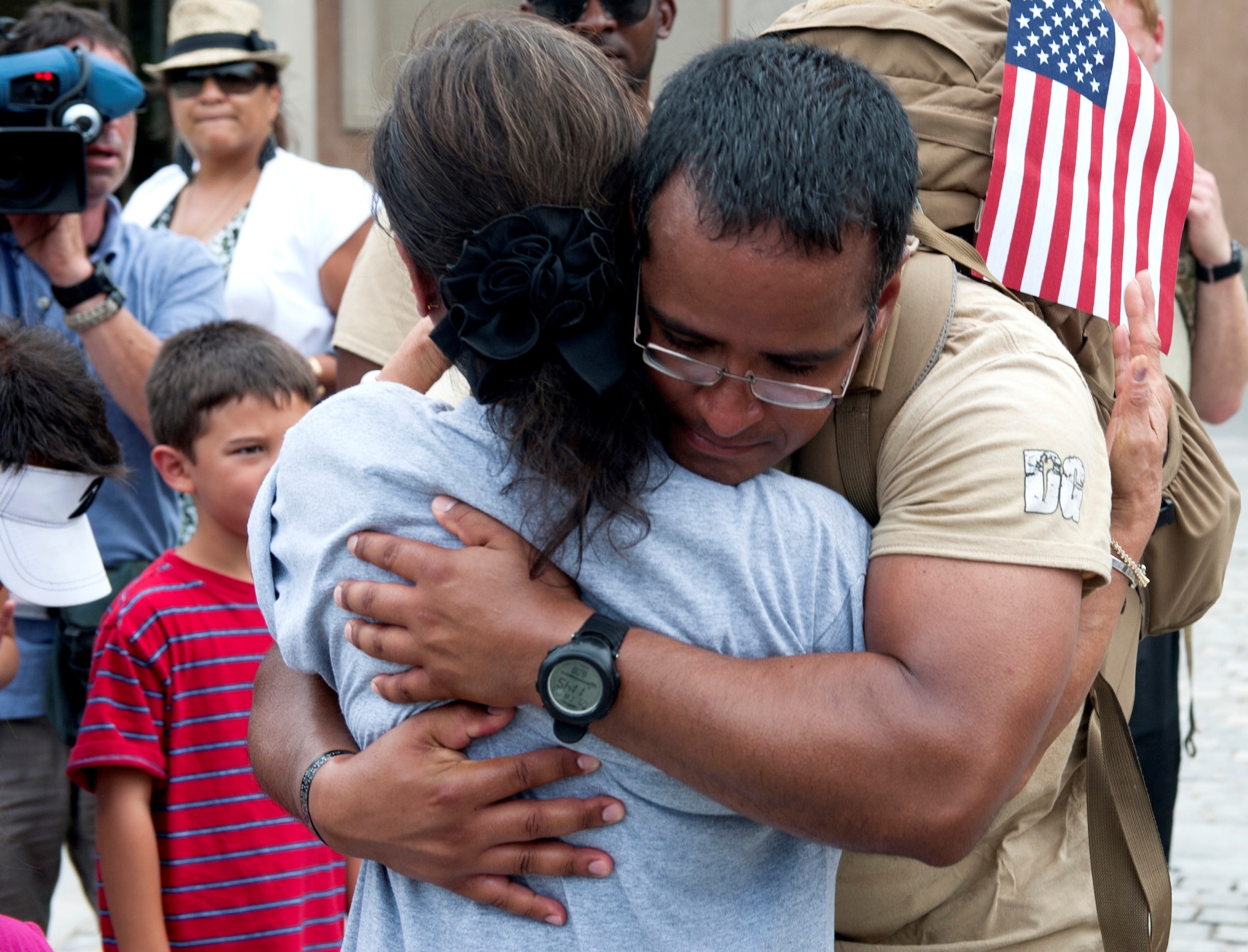 Staff Sgt Angel Montes hugs Maj. David Gray’s mother after his arrival to Arlington National Cemetery with “Delta Flight” Tactical Air Control Party specialists, Aug. 8, 2103. “DG” 140 is a 140-mile memorial ruck march for Maj. David Gray, beginning at the Casualty Reception Center at Dover Air Force Base, Del., to 
Gray’s headstone at Arlington National Cemetery in Washington, Aug 4-8. The TACPs are from the 13th Air Support Operations Squadron, Fort Carson, Colorado. (U.S. Air Force photo/Senior Airman Carlin Leslie)