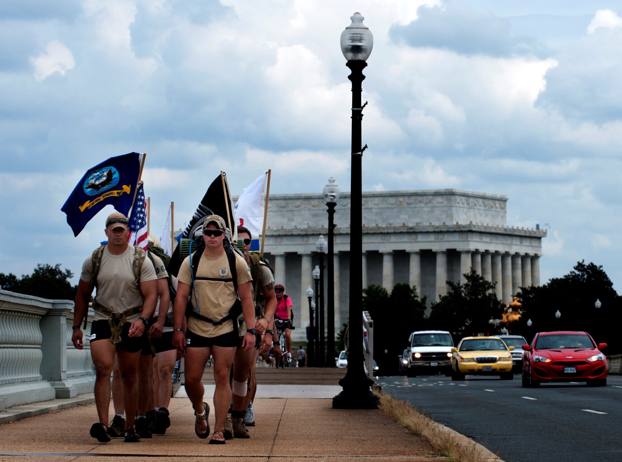 Airmen from the 13th Air Support Operations Squadron cross the Arlington National Bridge en route to Arlington National Cemetery to honor a fallen comrade Maj. David Gray by completing the “DG” 140, Aug. 8, 2013. “DG” 140 is a 140-mile memorial ruck march for Maj. David Gray, beginning at the Casualty Reception Center at Dover Air Force Base, Del., to  Gray’s headstone at Arlington National Cemetery, Aug 4-8. (U.S. Air Force photo/Senior Airman Carlin Leslie)
