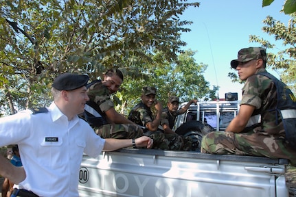 Maj. Jeremy Holmes, of the Wisconsin National Guard's Military Engagement Team (MET), shares a laugh with members of Nicaragua's humanitarian rescue team in Managua, Nicaragua, Jan. 31, 2013.