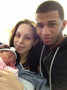 New mom Ericka Bueno poses for a picture with her boyfriend Joel Gonell and their newborn daughter Nohely at the UMass Memorial Medical Center in Worcester, Mass., Feb. 9, 2013.