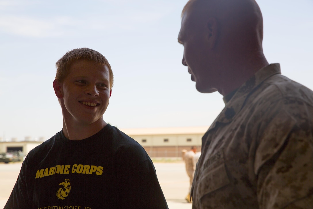 Jefferson Rynewart, left, a poolee from  Recruiting Substation Boise, Idaho, and a Boise native, speaks to Gunnery Sgt. Wesley Nation, right, airframes division chief with Marine Fighter Attack Squadron 232, 3rd Marine Aircraft Wing, and a Glasgow, Mo., native, during a visit to the squadron aboard Mountain Home Air Force Base, Idaho, July 29. Rynewart was one of 12 poolees invited by the commanding officer to learn about the squadron. 