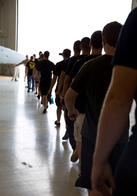 Poolees from Recruiting Substation Boise, Idaho, walk toward an F/A-18C Hornet during a visit to Marine Fighter Attack Squadron 232 aboard Mountain Home Air Force Base, Idaho, July 29. Poolees learned about military occupational specialties from noncommissioned officers in the squadron and saw an F/A-18C Hornet up close. 