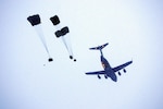 A flight crew with the Alaska Air National Guard's 249th Airlift Squadron conducts an equipment drop from a C-17 Globemaster III during an arctic search-and-rescue exercise Feb. 8, 2013.
