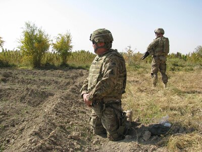 U.S. Army Reserve Col. Frank Kestler prays at the Afghanistan field near Arif Kala where his stepson, 1st Lt. Joseph Theinert, was killed in combat in June, 2010.