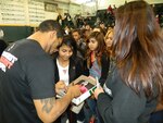 New fans mob Joe Pacheco, a mixed martial artist with Bellator Fighting Championships, at a Cabarrus High School Healthy Living and Anti-Bullying seminar for the students Feb. 12, 2013.