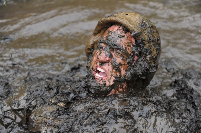 A sergeant instructor emerges from The Quigley, a series of water obstacles, during the Combat Course at Officer Candidates School on May 22, 2013. The OCS staff goes through the obstacles before each training cycle to reaquaint themselves with the different courses.