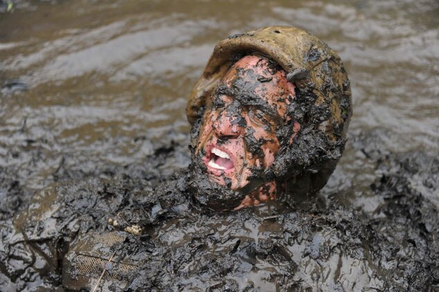 A sergeant instructor emerges from The Quigley, a series of water obstacles, during the Combat Course at Officer Candidates School on May 22, 2013. The OCS staff goes through the obstacles before each training cycle to reaquaint themselves with the different courses.