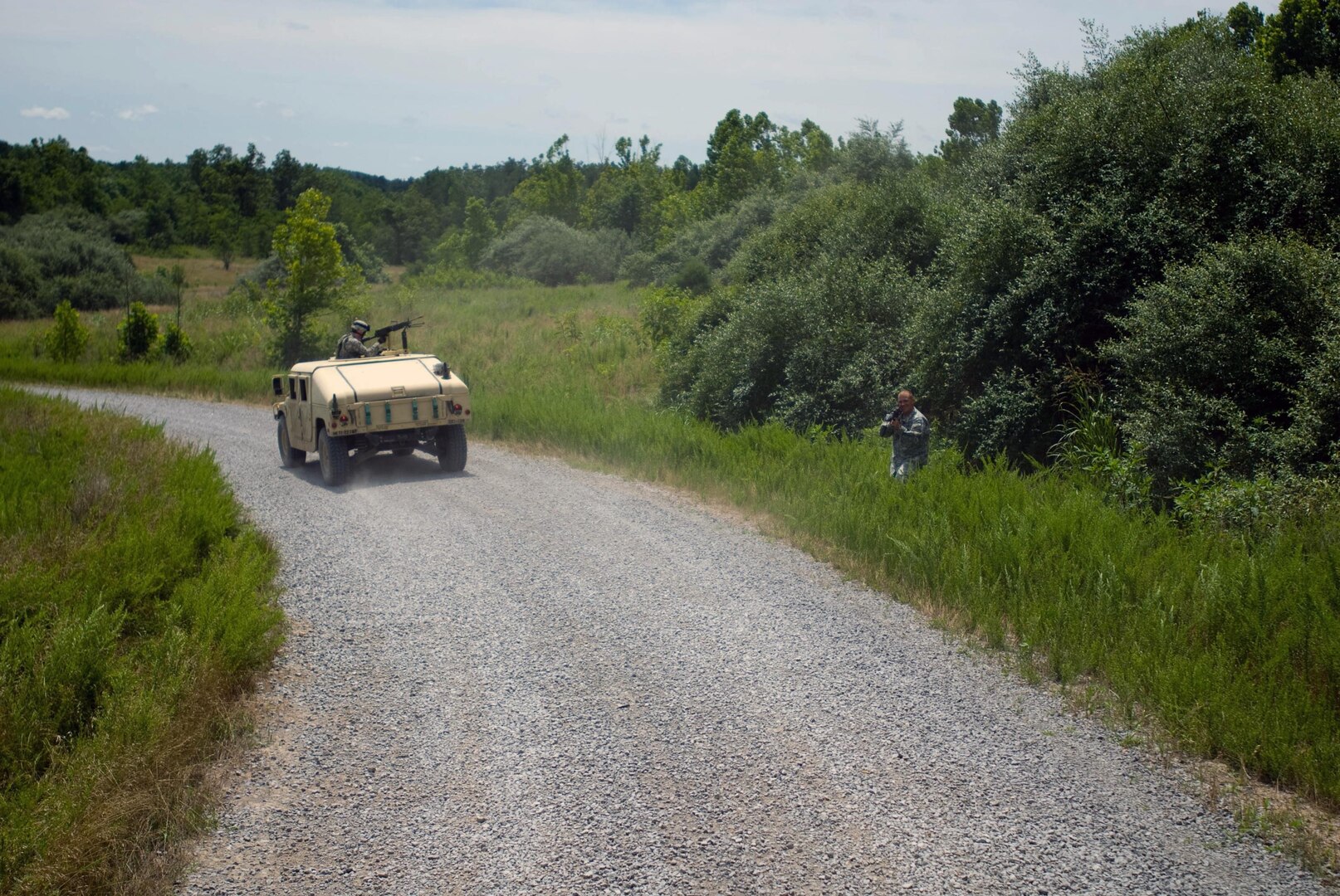An 'insurgent' pops from the nearby trees to ambush a mounted patrol during the 1204th Aviation Support Battalion's pre-mobilization training at the Wendell H. Ford Regional Training Center in Greenville, Ky., June 24, 2011. The installation won an environmental award recently.