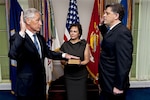 Chuck Hagel is sworn into office Feb. 27, 2013, by Michael L. Rhodes, the Defense Department's director of administration and management, as Hagel's wife, Lilibet, holds a Bible at the Pentagon.