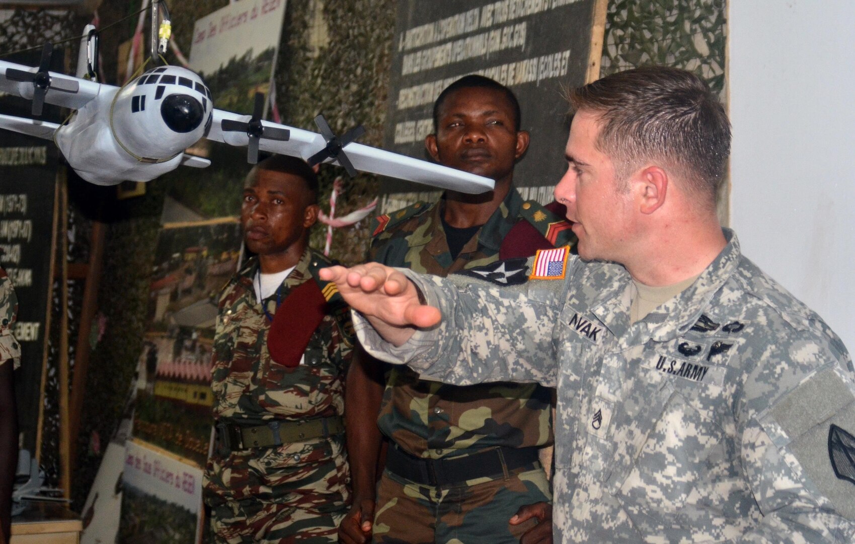Georgia National Guard Staff Sgt. Ray Novak, right, leads a class on drop zone operations for Cameroon Army paratroopers Feb. 21, 2013. Novak is among more than 150 U.S. service members working with nearly 600 Cameroon and Central African partner militaries to enhance aerial resupply, patient treatment and medical readiness procedures.