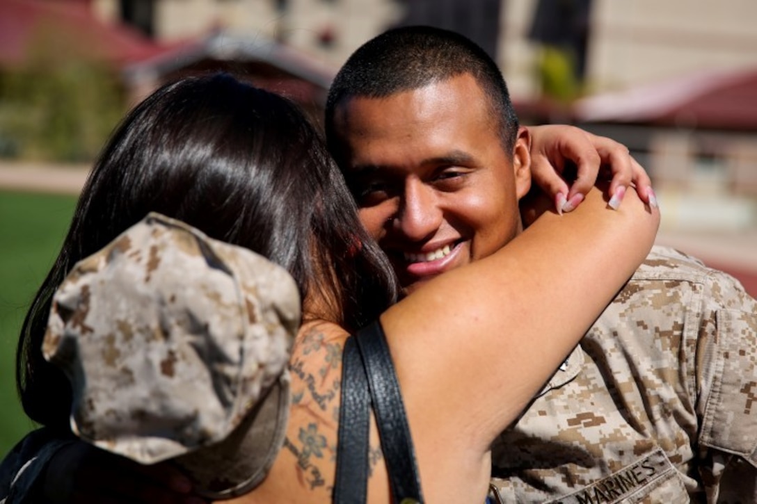 Sergeant Carlos Sanchez, engineer chief, Regimental Combat Team 7, and a native of Little Falls, N.J., embraces his wife Mercedes for the first time in nearly a year aboard Camp Margarita here, Aug. 7. The first main body of RCT-7 personnel returned to family and friends after being deployed approximately 10 months. The servicemembers worked with Afghan forces while deployed to Southwest Afghanistan.