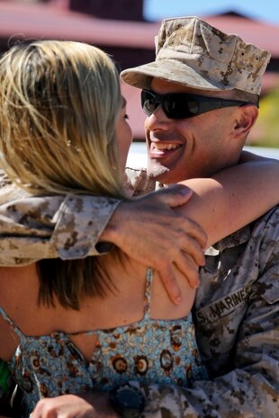 Lieutenant Col. Vincent Laratta, regimental judge advocate, Regimental Combat Team 7, and a native of Denver, embraces his wife Dione for the first time in approximately 10 months aboard Camp Margarita here, Aug. 7. Family and friends waited for the Marines as they arrived at Camp Pendleton. The servicemembers worked with Afghan forces while deployed to Southwest Afghanistan.