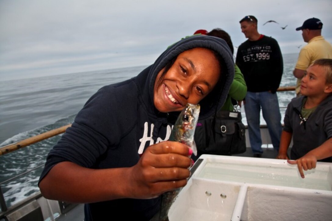 130808-M-ST621-142 DANA POINT, Calif., -- (Aug. 7, 2013) Kouriahna, 12, shows off her bait during a youth fishing trip aboard the fishing vessel Clemente, Aug. 7. Marines and sailors volunteered their time to take youths on an all-day fishing trip sponsored by Wild Game Feed. (U.S. Marine Corps Photo by Cpl. Emmanuel Ramos/Released)
