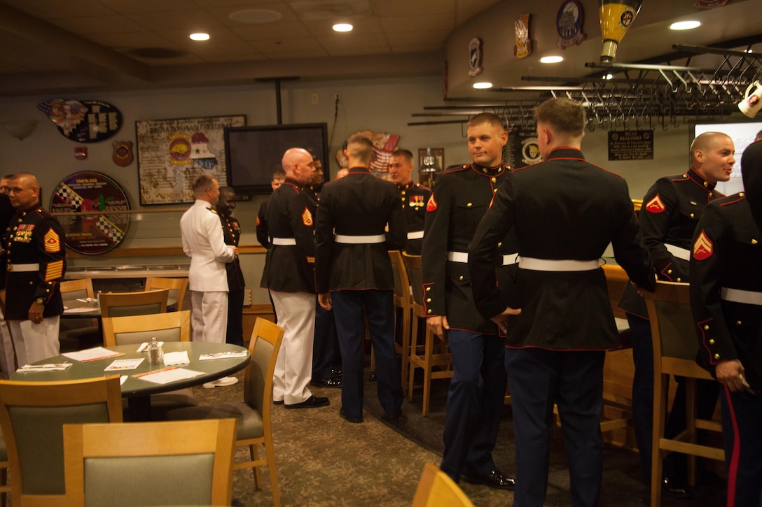 Marines with Marine Air Control Squadron 2 Detachment Alpha, gather for cocktail prior to their mess night at the bar of the Marine Corps Air Station Beaufort Officers’ Club, Aug. 1. Mess night is one of many Marine Corps traditions which allow the unit to come together and build camaraderie amongst one another.