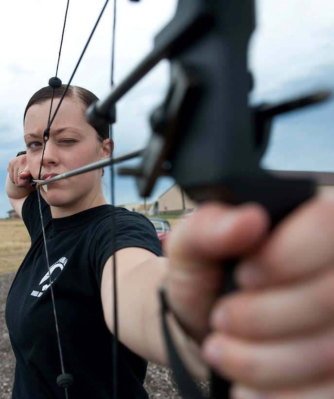 Airman 1st Class Samantha Rule takes aim at a target during the opening of the new archery range Aug. 1, 2013, at Ellsworth Air Force Base, S.D. The 28th Force Support Squadron separated the archery range from the trap and skeet area to allow both facilities to be utilized simultaneously, while giving Airmen a bigger range and more options. Rule is a command administrator assigned to the 28th Bomb Wing Staff. (U.S. Air Force photo/Airman 1st Class Alystria Maurer)