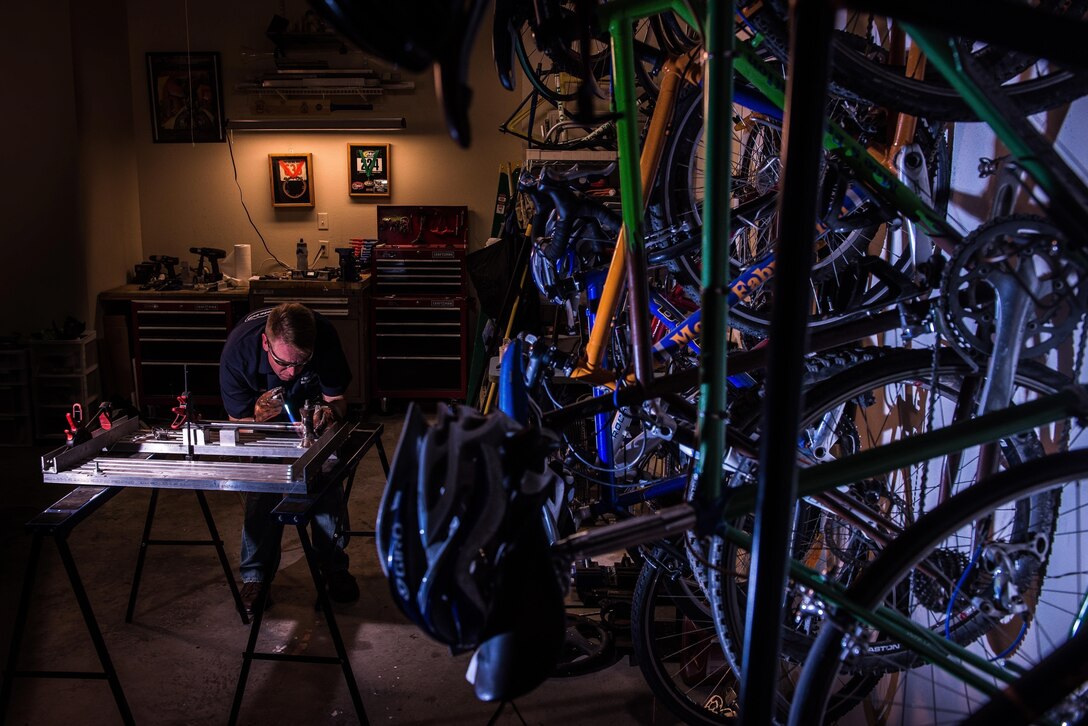 Senior Master Sgt. Maurice Milstead  works on a bicycle frame July 23, 2013, in Austin, Ark. Milstead builds custom bikes, including the $4,500 model that was destroyed in 2012 when a passing motorist sideswiped him. Milstead is the 19th Equipment Maintenance Squadron fabrication flight superintendent. (U.S. Air Force photo/Staff Sgt. Russ Scalf)