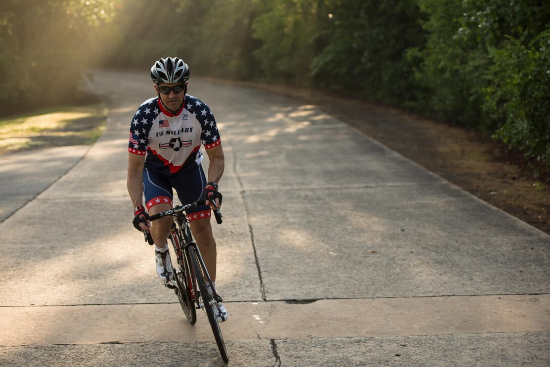 Chief Master Sgt. Devery Andrews 
rides his bicycle July 23, 2013, at Little Rock Air Force Base, Ark. Andrews suggests riders follow the rules of the road to gain respect for all cyclists. Andrews is the superintendent of the19th Component Maintenance Squadron. (U.S. Air Force photo/Staff Sgt. Russ Scalf)