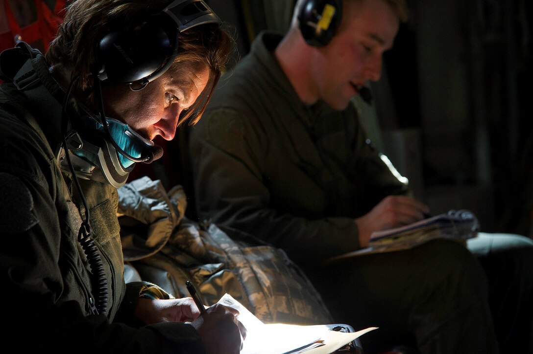 First Lt. Christi Nance  and Senior Airman Ulrich Deyoung document their patient's condition during an in-flight medical training scenario on a C-130 Hercules July 27, 2013. The training is part of Warrior Exercise 86-13-01 (WAREX)/Exercise Global Medic 2013. WAREX provides units an opportunity to rehearse military maneuvers and tactics. Held in conjunction with WAREX, Global Medic is an annual joint-field training exercise designed to replicate all aspects of theater combat medical support. Nance is a flight nurse and Deyoung is an aeromedical evacuation technician, both assigned to the 446th Aeromedical Evacuation Squadron at Joint Base Lewis-McChord, Wash. (U.S. Air Force photo/Tech. Sgt. Efren Lopez)
