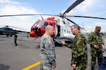 Maj. Gen. Robert E. Livingston, Jr., the adjutant general of South Carolina, speaks with Colombian Army Maj. Gen. Jorge Salgado, army planning and transformation, in front of a Colombian army Mi-17 search and rescue helicopter, in Tolemaida, Colombia, Feb. 21, 2013.