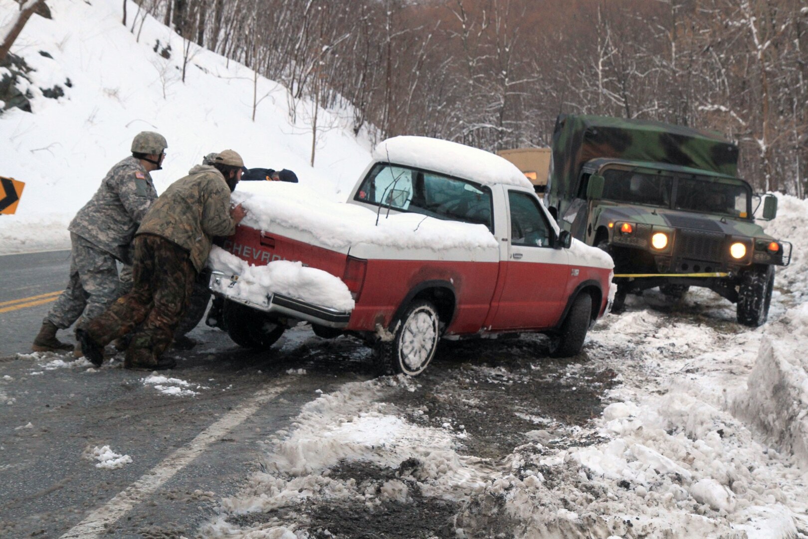 Soldiers from the Charlottesville-based Company C, 429th Brigade Support Battalion, 116th Infantry Brigade Combat Team work with Virginia officials to clear an abandoned vehicle March 6, 2013, near Nellysford, Va.