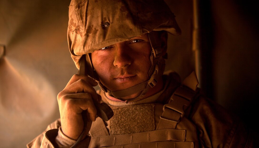 Lance Cpl. Austin Taylor, a Lake Wales, Fla., native and radio operator with Golf Company, 2nd Battalion, 3rd Marine Regiment sits covered head to toe in "moon dust" that is billowing in and out the safety vehicle he rides in. He diligently kept the radio phone to his ear, sending and receiving traffic from "Gladiator" main during a company-level live-fire mechanized assault as part of Exercise Lava Viper in the Pohakuloa Training Area, Hawaii, July 23, 2013. Lava Viper is a battalion-level combined-arms exercise designed to enhance the skills of the ground combat and support element Marines participating. (U.S. Marine Corps photo by Cpl. Matthew Callahan)