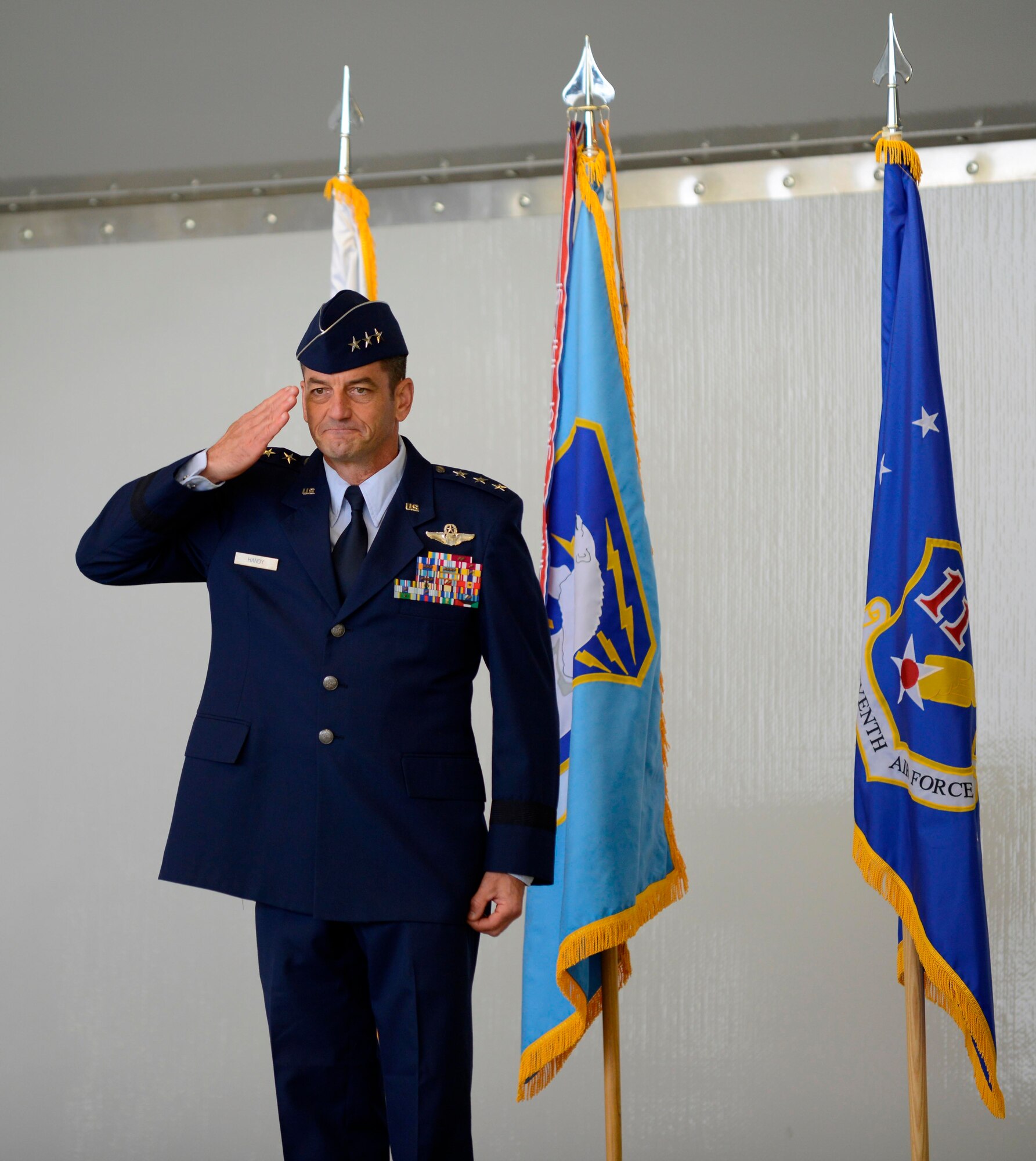Air Force Lt. Gen. Russell J. Handy returns his first salute from the members of the Alaskan Command, 11th Air Force and Alaskan North American Aerospace Defense Command Region at the change-of-command ceremony August 9.  Handy previously served at Joint Base Elmendorf-Richardson, Alaska, from July 2003 to August 2005 as the commander of the 3rd Operations Group.  (U.S. Air Force photo/Tech Sgt. Raymond Mills)