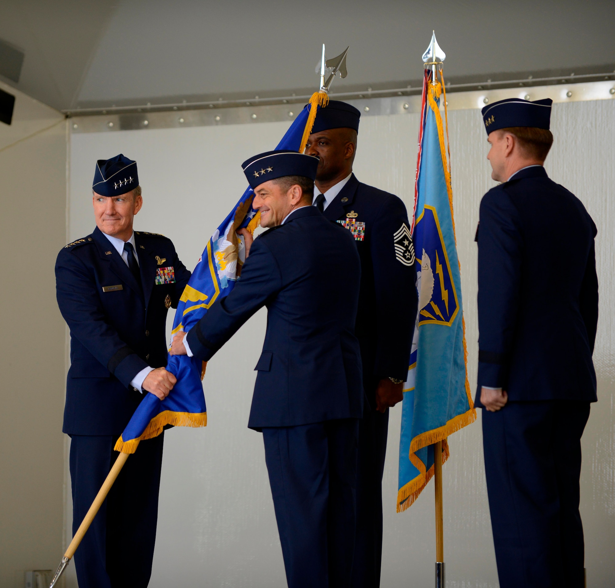 Air Force Lt. Gen. Russell J. Handy (center) assumes command of the 11th Air Force from Air Force Gen. Herbert J. Carlisle at the change-of-command ceremony here August 9.  Carlisle is commander of Pacific Air Forces.  The 11th AF supports and provides air operations, crisis response, and movement of forces in the Pacific. (U.S. Air Force photo/Tech Sgt. Raymond Mills)