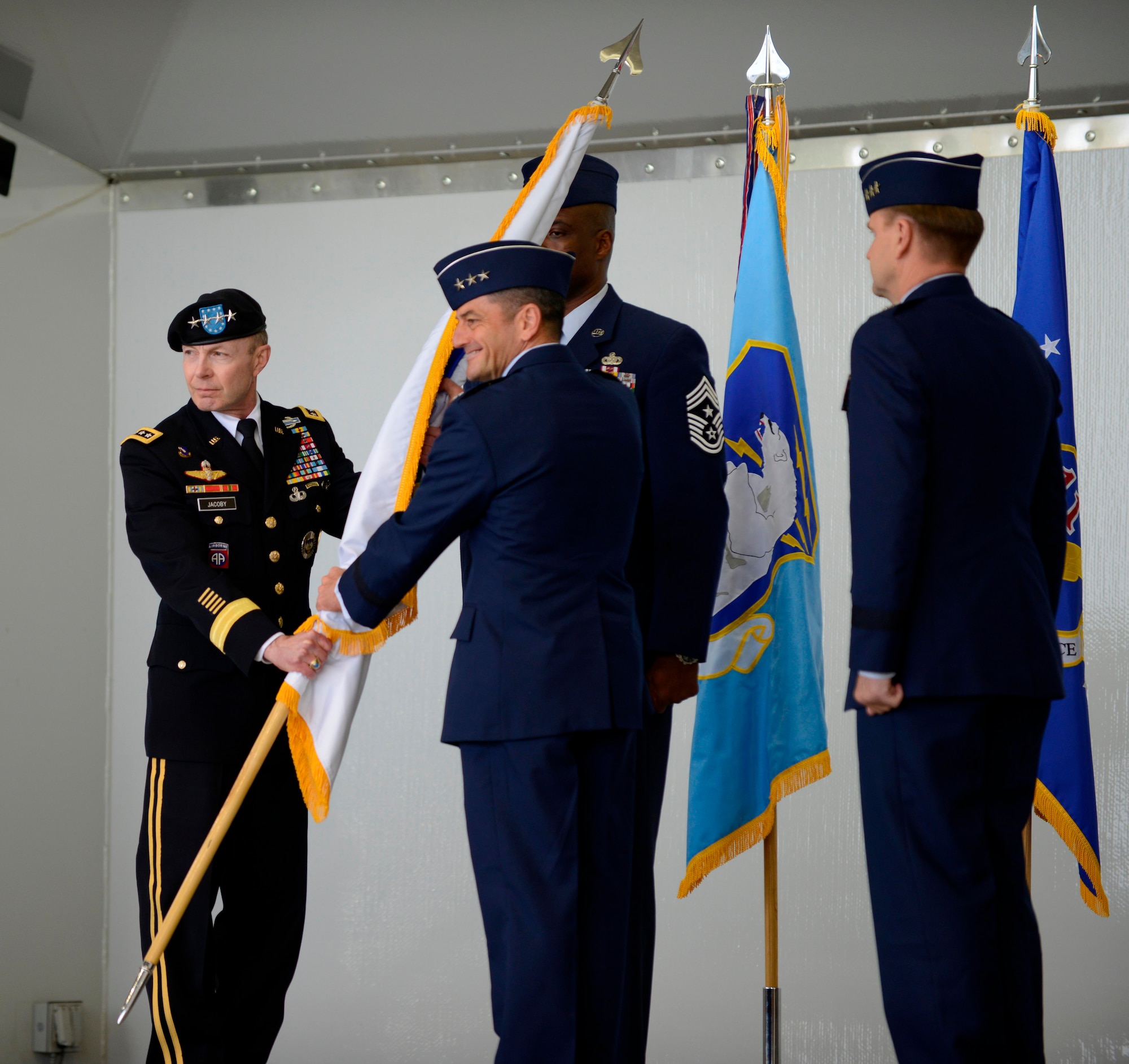 Air Force Lt. Gen. Russell J. Handy (center) assumes command of the Alaskan North American Aerospace Defense Command Region from Army Gen. Charles H. Jacoby, Jr. at the change-of-command ceremony Aug. 9.  Jacoby is commander of North American Aerospace Defense Command and U.S. Northern Command. Alaskan NORAD region provides an ongoing capability to detect, validate, and warn of any aircraft or cruise missles within its area of operations that could threaten North American security. (U.S. Air Force photo/Tech Sgt. Raymond Mills)