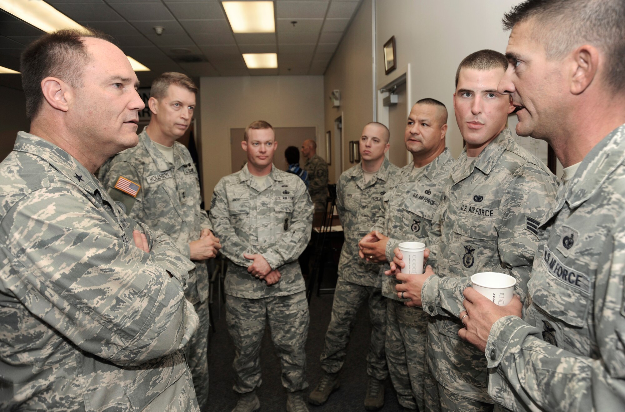 Oregon Brig. Gen. Michael Stencel (left), Assistant Adjutant General for Air and Maj. Gen. Daniel Hokanson, Oregon Adjutant General, talk with Staff Sgt. Matthew Ritchie (far right) and other members of the 142nd Fighter Wing Security Forces Squadron during a USO event as part of their in processing at the Portland Air National Guard Base, Ore., Aug. 9, 2013.  (Air National Guard photo by Tech. Sgt. John Hughel, 142nd Fighter Wing Public Affairs/released)