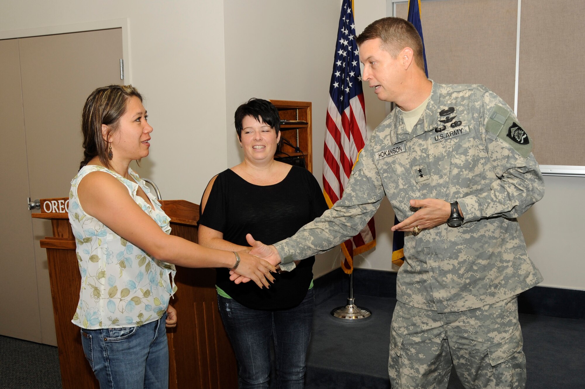 Maj. Gen. Daniel Hokanson, Oregon Adjutant General (right) thanks family support coordinators Tammy Davis (left) and Anndi Moore (center) for their volunteer efforts in support of the 142nd Fighter Wing Security Forces Squadron during their recent deployment after he addressed the group at the Portland Air National Guard Base, Ore., Aug. 9, 2013. (Air National Guard photo by Tech. Sgt. John Hughel, 142nd Fighter Wing Public Affairs/released)