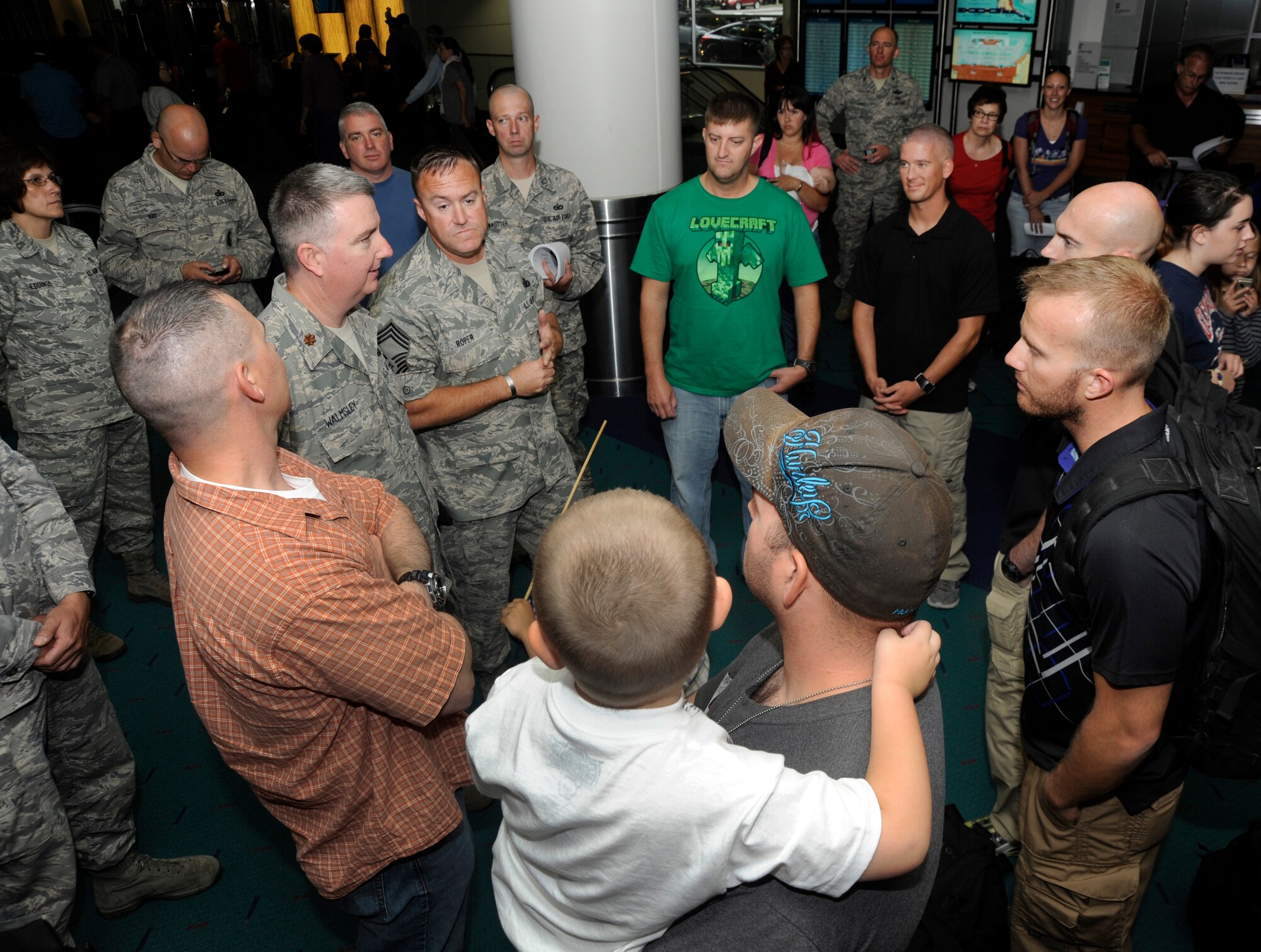 Members of the 142nd Fighter Wing Security Forces Squadron are welcomed back to Oregon at the Portland International Airport after their recent deployment, Aug. 8, 2013. A total of 26 Airmen from the 142nd Fighter Wing spent six months in Qatar in support of Operation Enduring Freedom. (Air National Guard photo by Tech. Sgt. John Hughel, 142nd Fighter Wing Public Affairs/released)