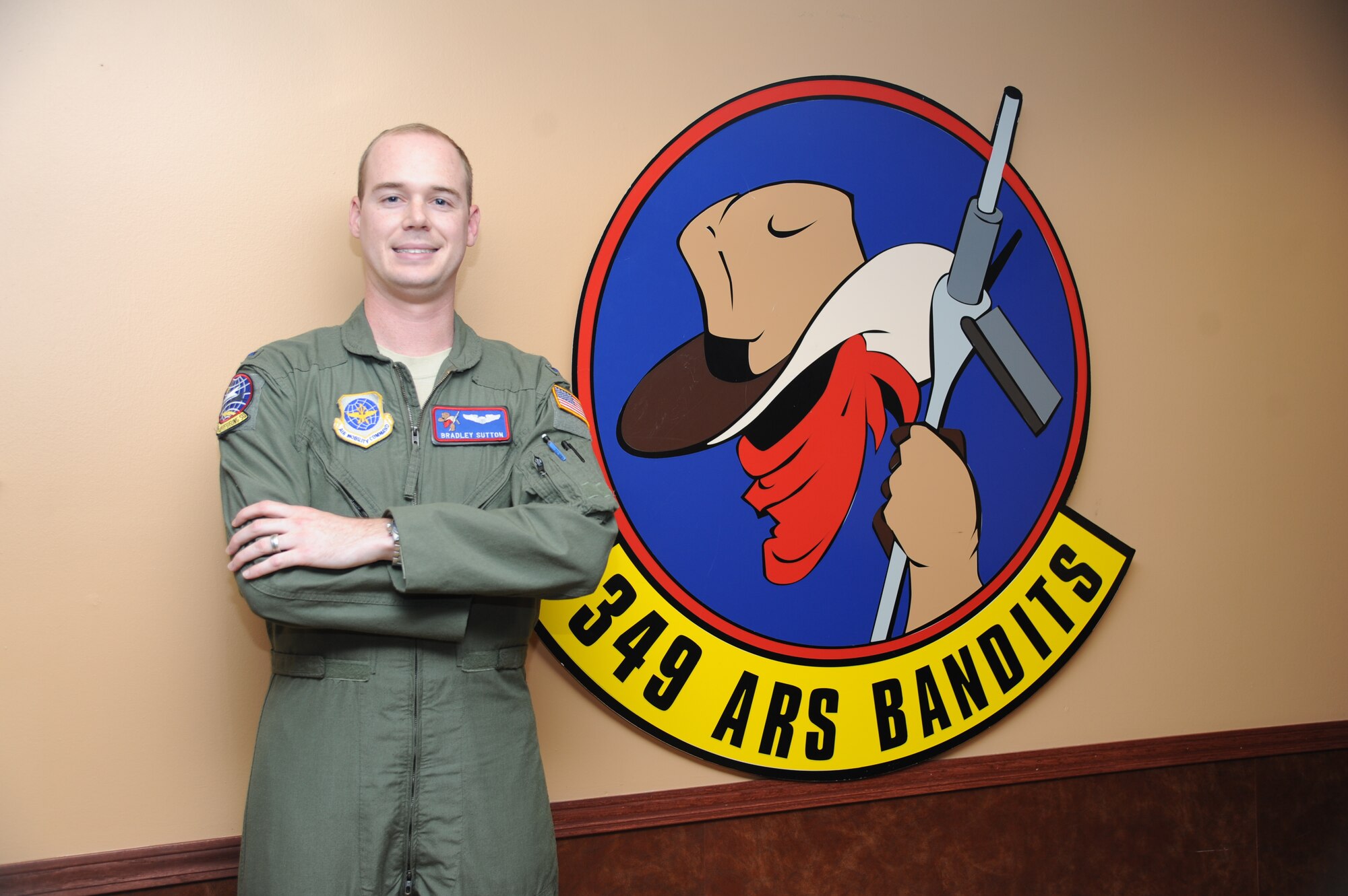 First Lieutenant Bradley Sutton, 349th Air Refueling Squadron pilot, stands in front of his squadron’s wall art at McConnell Air Force Base, Kan., Aug. 9, 2013. Sutton was the first to respond to an off base vehicle accident, Aug. 3, involving a local man and provided assistance and first aid. (U.S .Air Force photo by Airman 1st Class John Linzmeier) 