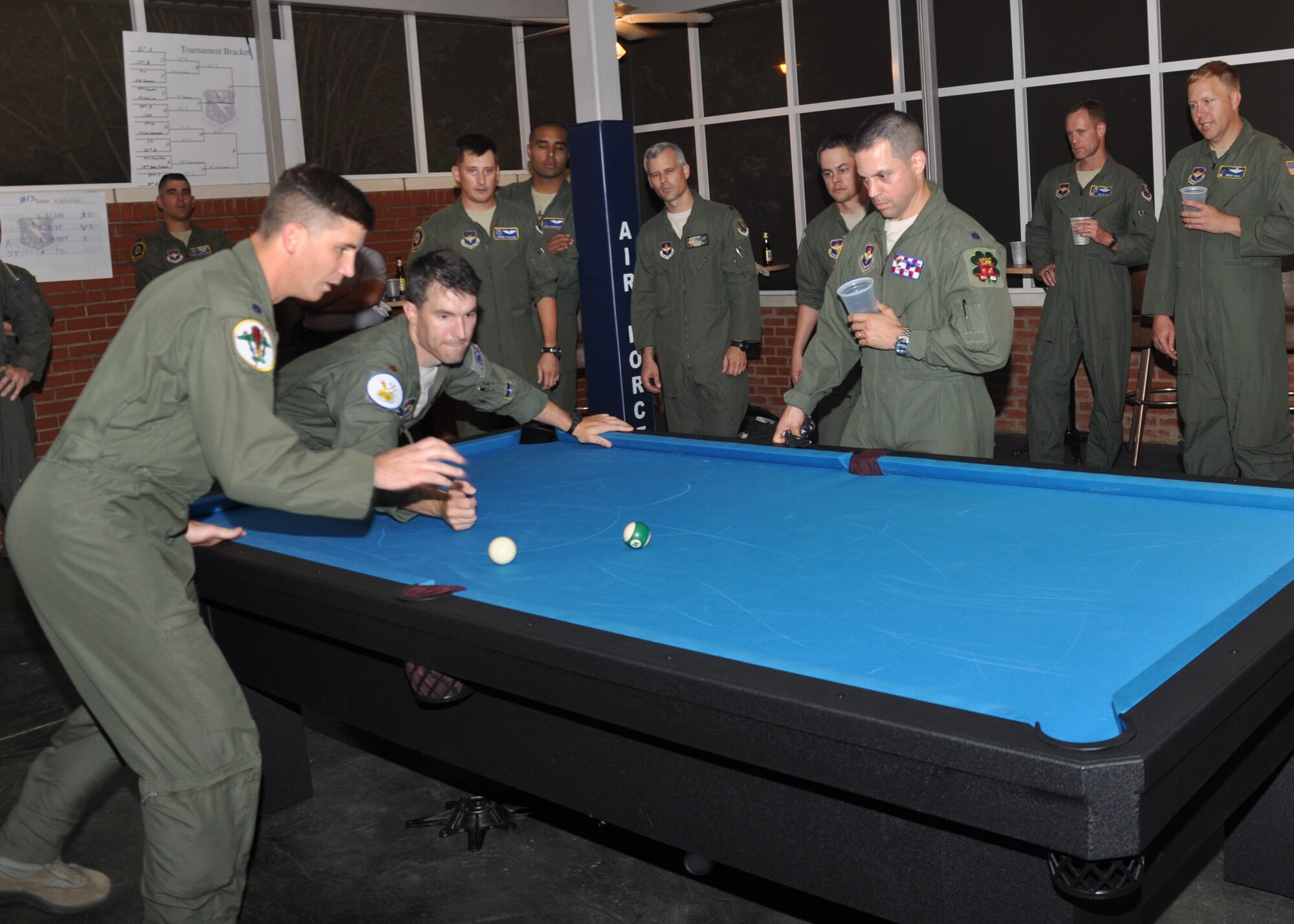 Lt. Col. PK Carlton III, 49th Fighter Training Squadron commander and Maj. Robert Faustmann, 14th Flying Training Wing, maneuver for position during the championship match of the Aug. 2 Crud tournament at the Columbus Club.  Faustmann, team captain for the 50th Flying Training Squadron, took home the inaugural trophy from the event. (U.S. Air Force Photo/Richard Johnson)