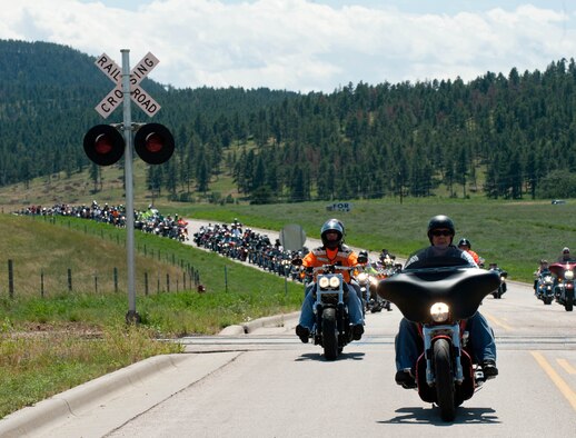 Senior Master Sgt. Danny Walker, 28th Logistics Readiness Squadron superintendent, and president of the Green Knights Dakota Thunder Motorcycle Club, leads the pack during the 2013 Dakota Thunder Run Aug. 6, 2013. During the run, cyclists were encouraged to ride in a staggered formation to ensure a safe and enjoyable trip through the Black Hills. (U.S. Air Force photo by Airman 1st Class Zachary Hada/Released)
